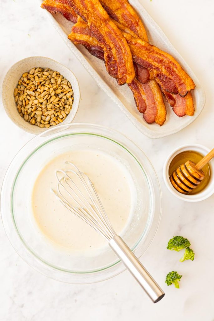 Creamy salad dressing in a bowl for a classic broccoli salad. 