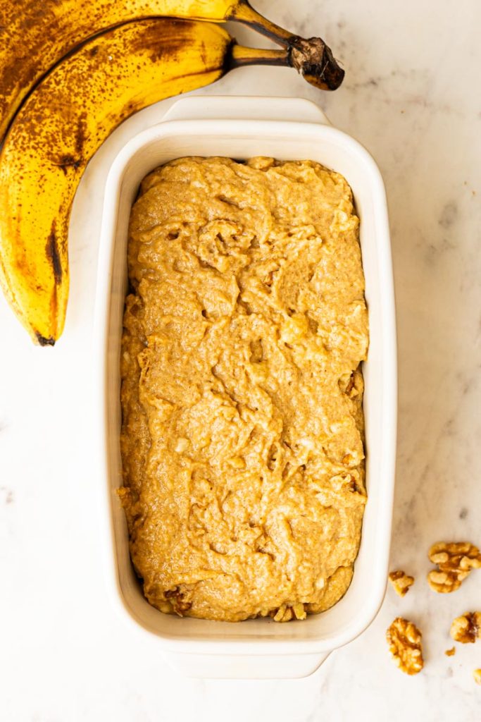 Healthy banana bread batter in a bread loaf pan.