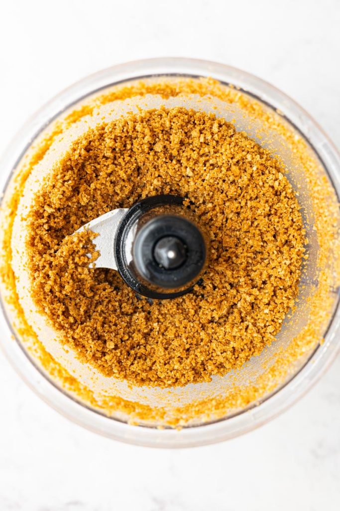 Graham cracker crumbles inside a food processor.