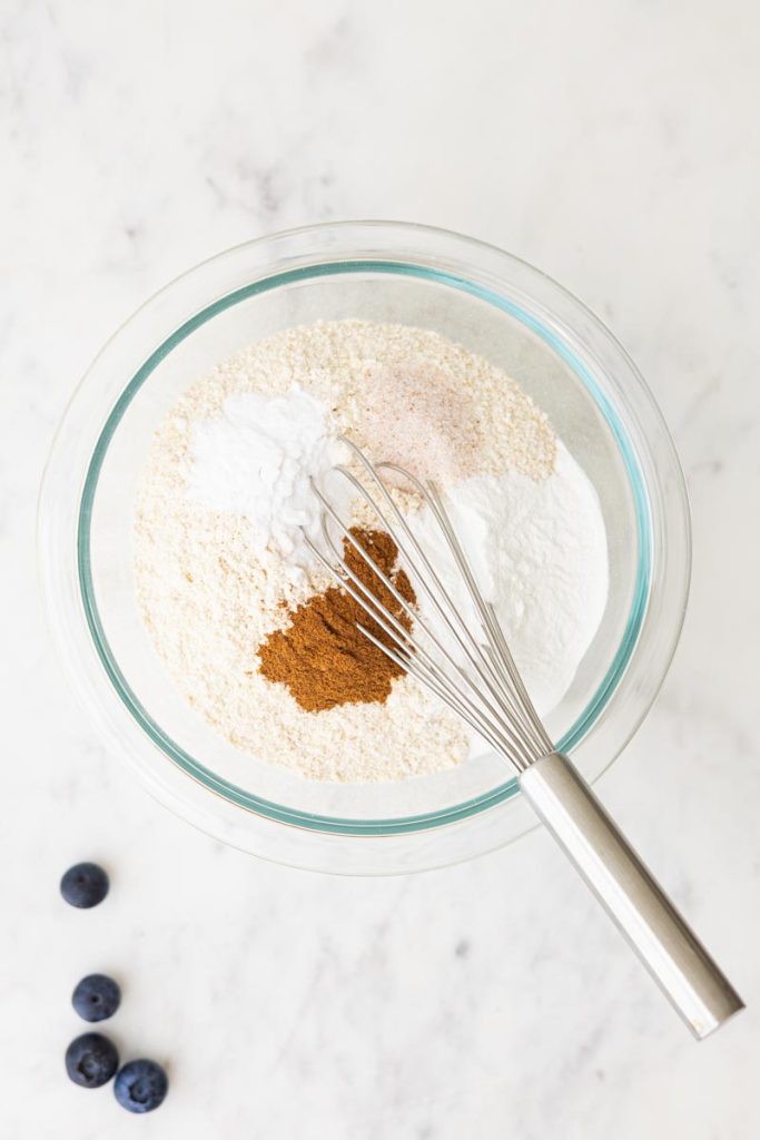 a glass bowl with dry ingredients to make fluffy whole wheat waffles