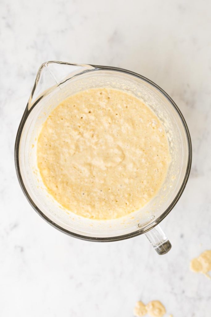 a large measuring cup with fluffy whole wheat waffle batter
